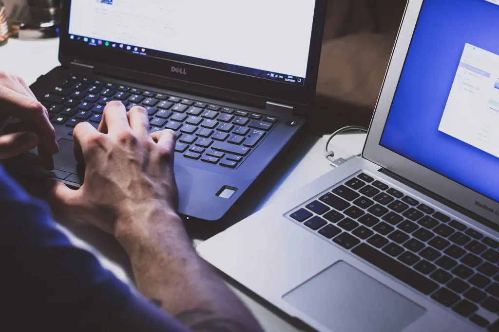 IT professional typing on a laptop